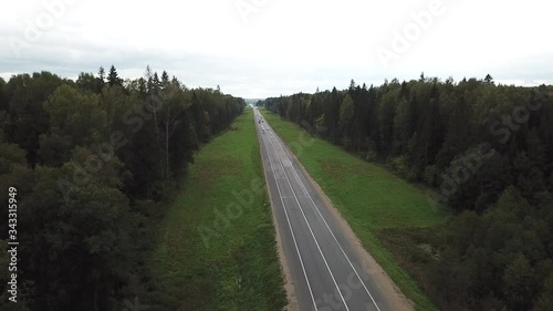 4K aerial summer cloudy day high quality video footage of forest gravel roads and federal highway connecting Moscow and Yaroslavl in Moscow region of Russia photo