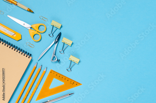 Back to school concept colorfull flatlay. Pencils,notepad, ruler scissors and paper clips.Horizontal view copyspace photo