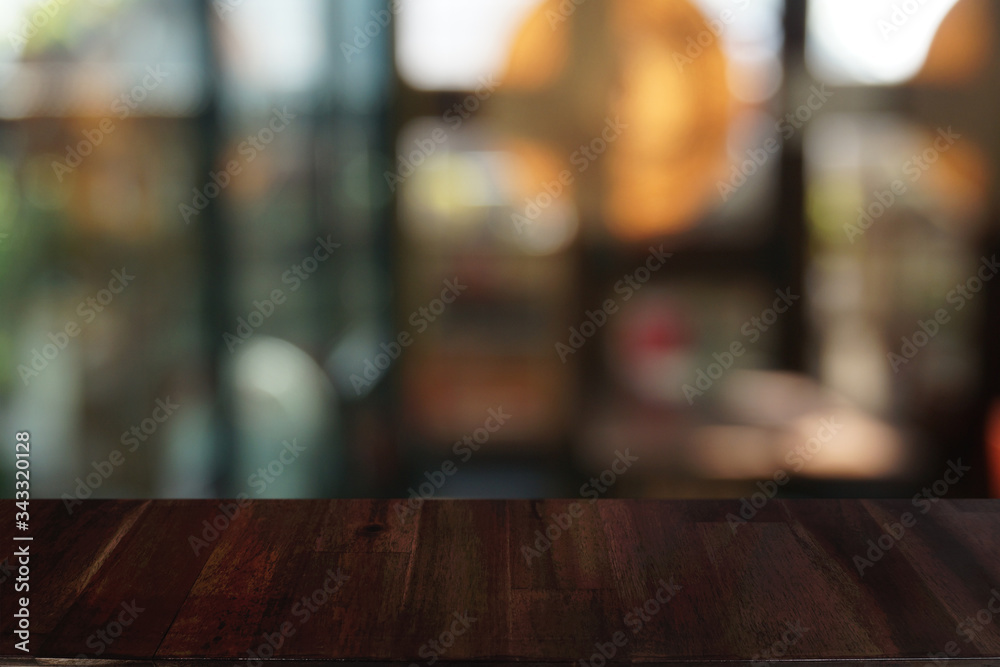 Empty dark wooden table in front of abstract blurred bokeh background of restaurant . can be used for display or montage your products.Mock up for space.