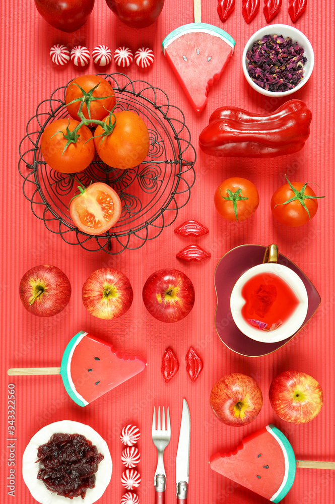 Red foods including apples, tomatoes, cranberry, watermelon, and red rose tea, with powerful healthy antioxidants, lycopene, anthocyanins, vitamin C. Creative concept flatlay. Vertical. Red foods including apples, tomatoes, cranberry, watermelon, and red rose tea, with powerful healthy antioxidants, lycopene, anthocyanins, vitamin C. Creative concept flatlay. Vertical.