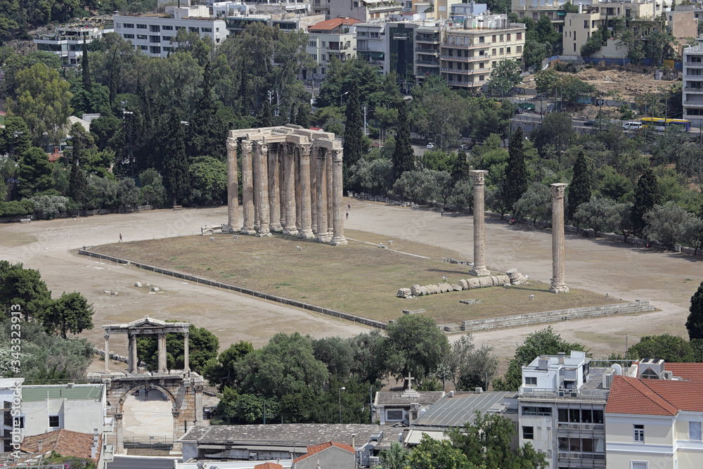 The remaining columns of the Temple of Olympian Zeus, completed in 131 AD, are shown from an elevated view with the Arch of Hadrian visible at bottom left during the 2010s.