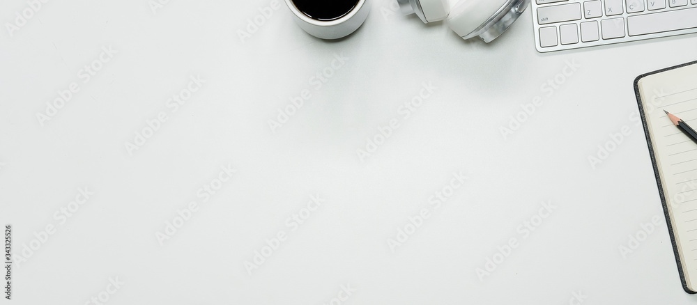 Top view white office desk table with blank notebook, computer keyboard and other office supplies. with copy space, flat lay. Top view white office desk table with blank notebook, computer keyboard and other office supplies. with copy space, flat lay.