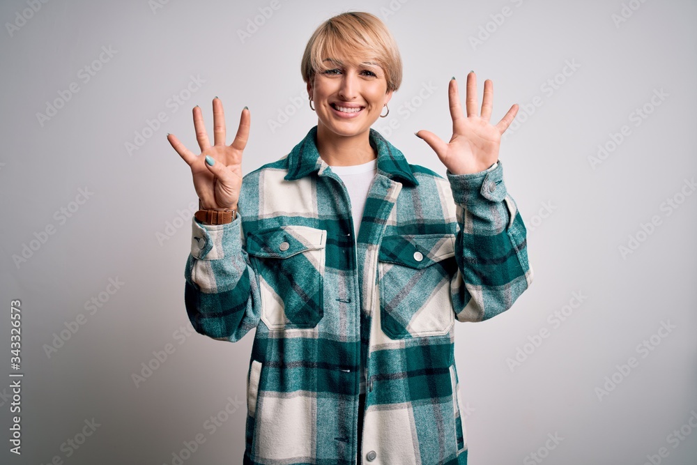 Young blonde woman with short hair wearing casual retro green shirt over isolated background showing and pointing up with fingers number nine while smiling confident and happy.