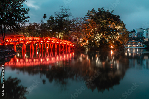 View of Hoan Kiem Lake Red Huc Bridge in Hanoi, Vietnam at night with long exposure photo