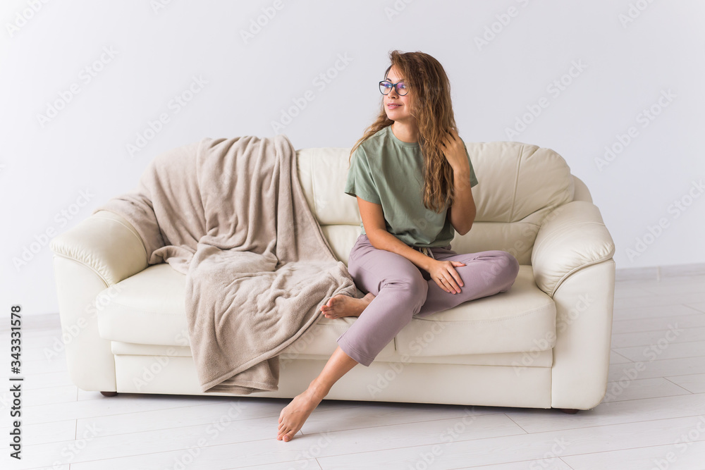 Coronavirus, Covid-19, Quarantine, isolation, coronavirus pandemic world. Stay at home. Bored woman spending time sitting on sofa at home.