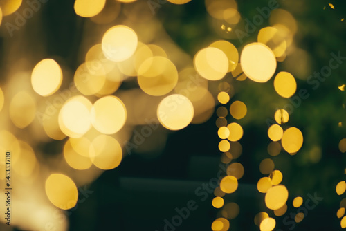 many of bokeh from light bulb tube on a street at night that look like luxury golden star light in dark background