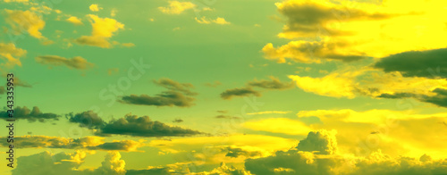 Canvas Print yellow sun bright in green sky with dim clouds