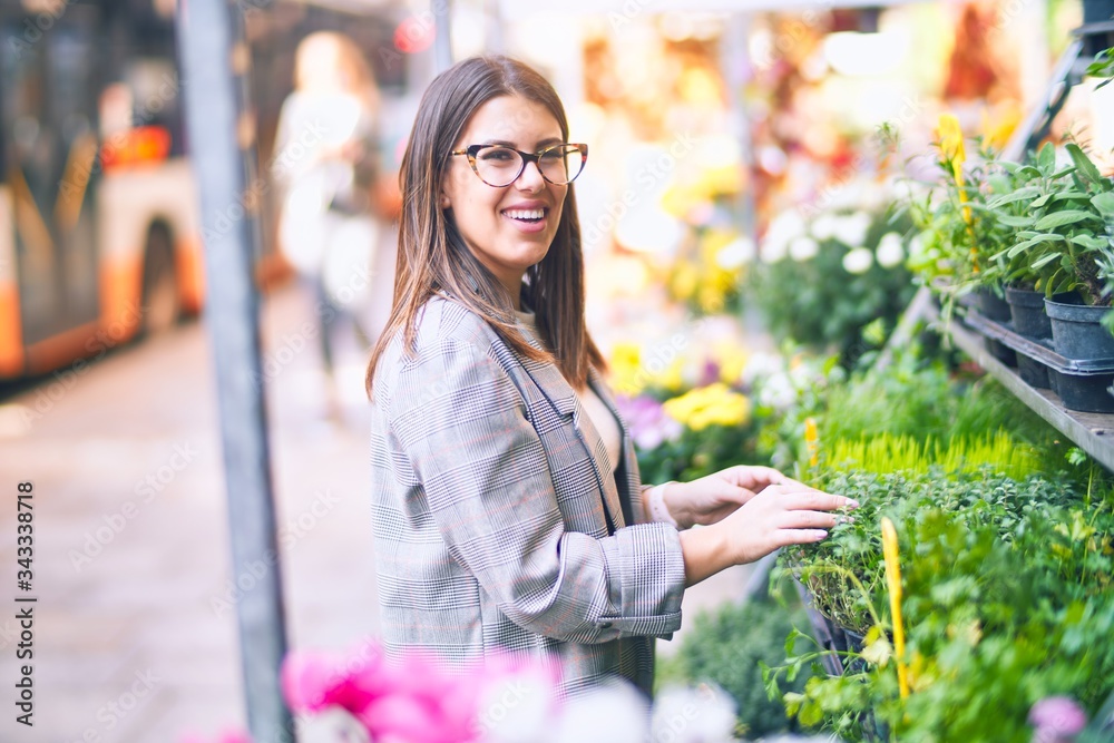 Young beautiful woman smiling happy and confident. Standing with smile on face at florist