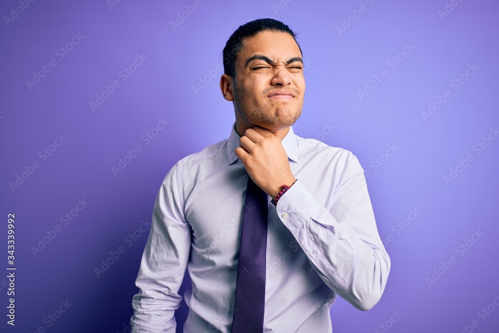 Young brazilian businessman wearing elegant tie standing over isolated purple background Touching painful neck, sore throat for flu, clod and infection Young brazilian businessman wearing elegant tie standing over isolated purple background Touching painful neck, sore throat for flu, clod and infection