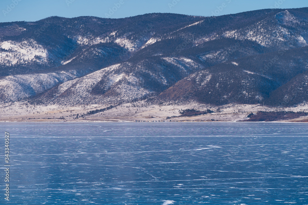 Baikal frozen lake with small village in winter season, Siberia, Russia