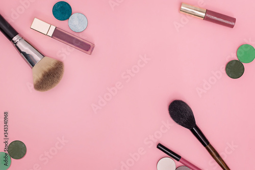 Flat lay of cosmetics on a bright colored background.