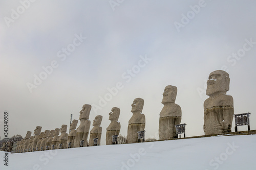 Moai, big stone statue in winter with snow on ground at hill of Budha Unseen Sapporo, Makomanai takino, Japan