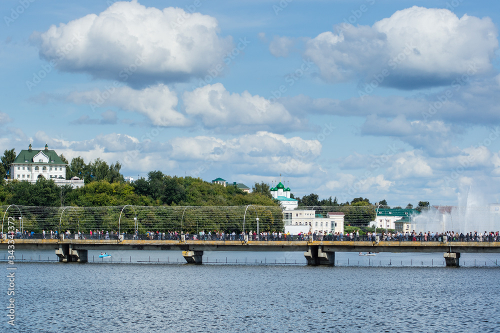 bridge over the bay with many people on theday of the celebration of the 550th anniversary  of the city of Cheboksary in 2019. Mass festivities in the Chuvash Republic in 2019.