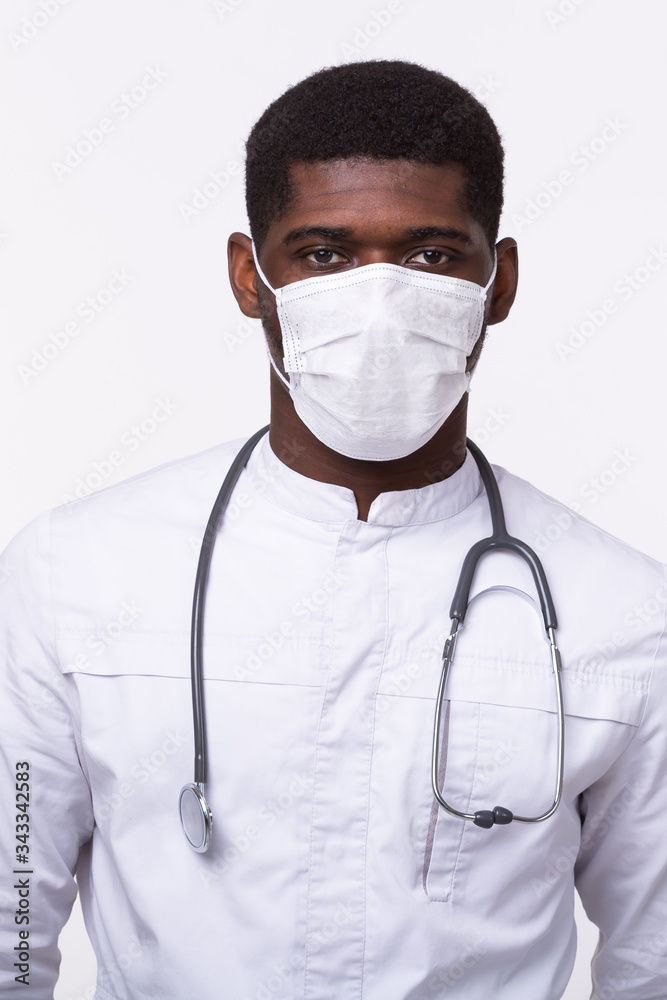 African american doctor in a mask over white background. Medicine, healthcare and people concept. African american doctor in a mask over white background. Medicine, healthcare and people concept.