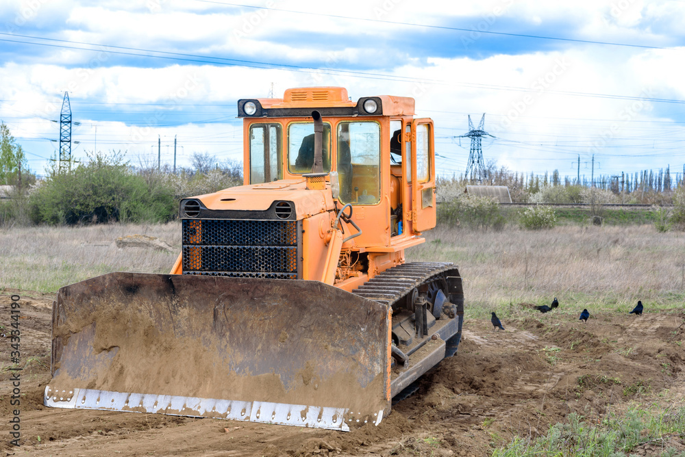 Industrial building construction site bulldozer leveling and moving soil during highway building Industrial building construction site bulldozer leveling and moving soil during highway building