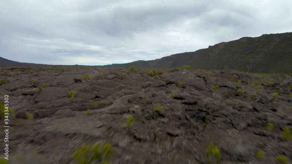 Cinematic low to the ground FPV drone shot of lava, Piton de la Fournaise, Reunion Island, France Cinematic low to the ground FPV drone shot of lava, Piton de la Fournaise, Reunion Island, France