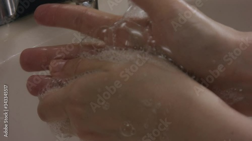 Wallpaper Mural white female hands carefully washing and cleaning her fingers really carefully with soap foam and bubbles in slow motion. with water sink in the background. Torontodigital.ca