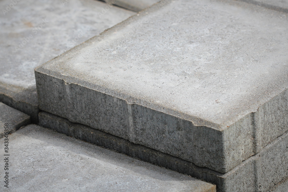 Stack of gray paving slabs. Laying the sidewalk of the tiles ...