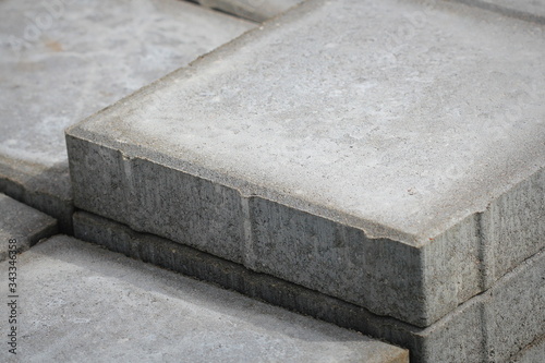 Stack of gray paving slabs. Laying the sidewalk of the tiles. Construction of sidewalks. Building materials for the construction of the sidewalk.