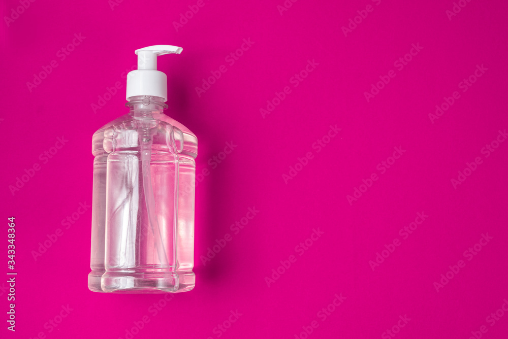 Container with alcohol gel on the red background Container with alcohol gel on the red background