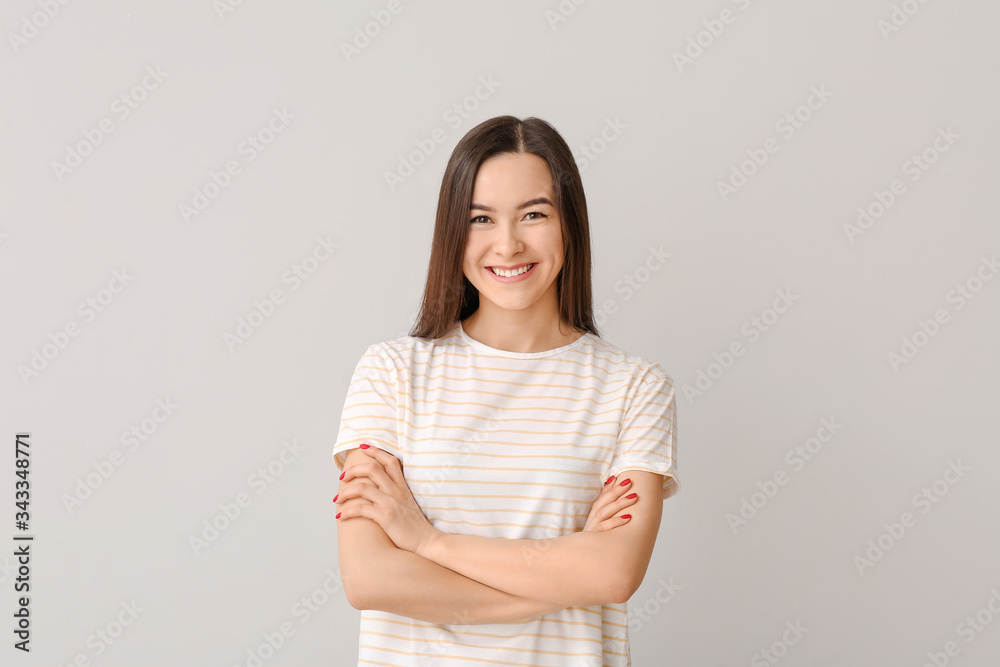 Portrait of beautiful young woman on grey background Portrait of beautiful young woman on grey background