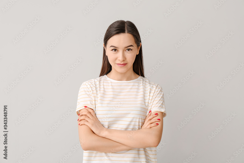 Portrait of beautiful young woman on grey background Portrait of beautiful young woman on grey background