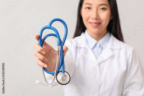 Female Asian doctor with st...