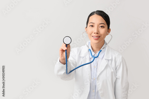 Female Asian doctor on ligh...