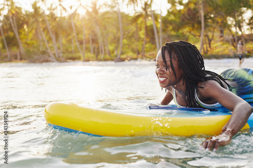 Photography Joyful excited young woman surfing in the ocean