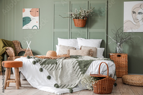 Interior of beautiful modern bedroom with spring flowers