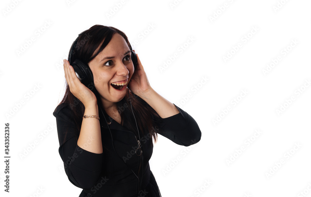 Crazy young woman in headphones isolated on a white background. Concept of the international day of music. Crazy young woman in headphones isolated on a white background. Concept of the international day of music.