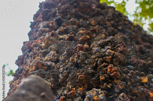 A wall made up of rock in which the front part is in focus and the background is blurred