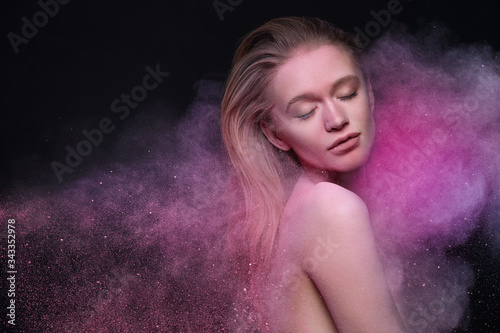 Fashion Beauty Makeup. Portrait Of Beautiful Sexy Young Woman Inside Motion Of Colorful Cloud Of Cosmetic Pink Blush Powder. Female Model With Flying Cosmetics Dust On Face And Body. High Resolution