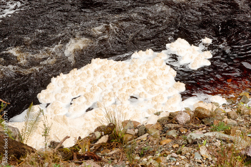 Foam forming on the water surface just downstream from the Lake Margaret dam spillway photo