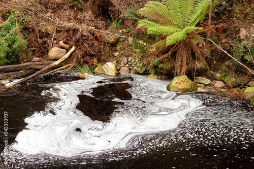 Foam forming on the water surface just downstream from the Lake Margaret dam spillway photo