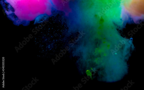 Abstract art powder paint on black background. Movement abstract frozen dust explosion multicolored on black background.