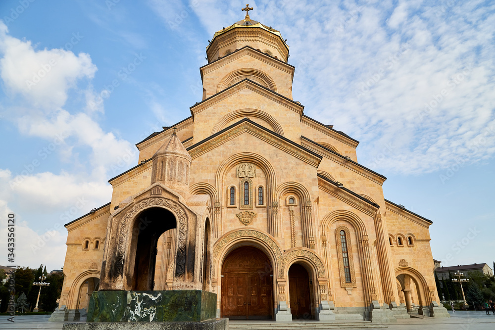 Fototapeta premium Big orthodox cathedral St. Trinity or Chirch Sameba in Tbilisi city in Georgia and blue sky background