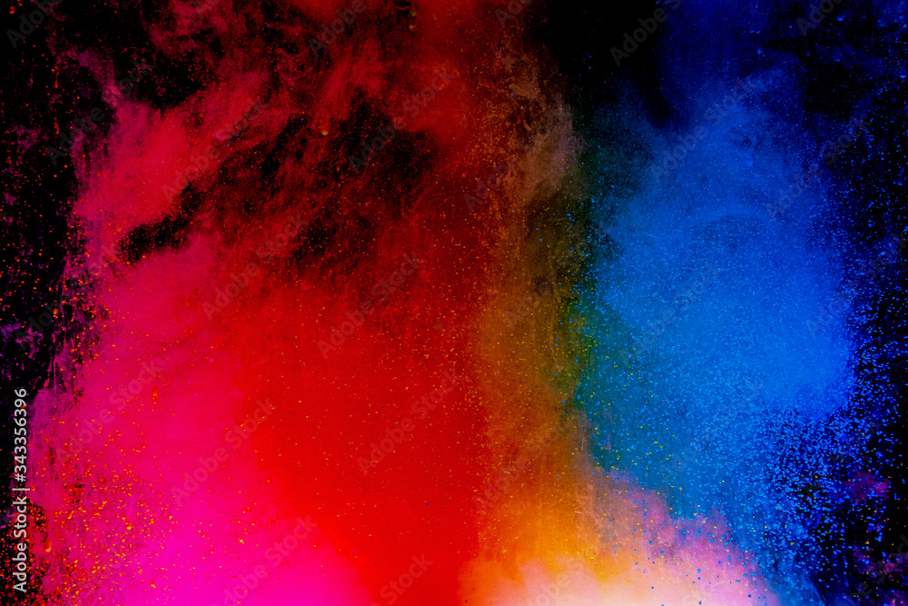 Abstract art powder paint on black background. Movement abstract frozen dust explosion multicolored on black background.