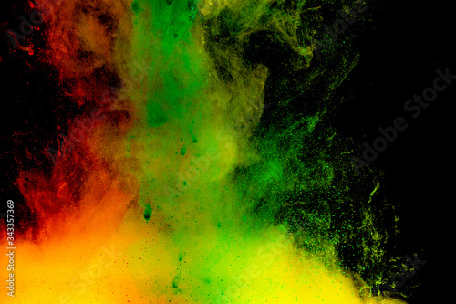 Abstract art powder paint on black background. Movement abstract frozen dust explosion multicolored on black background.