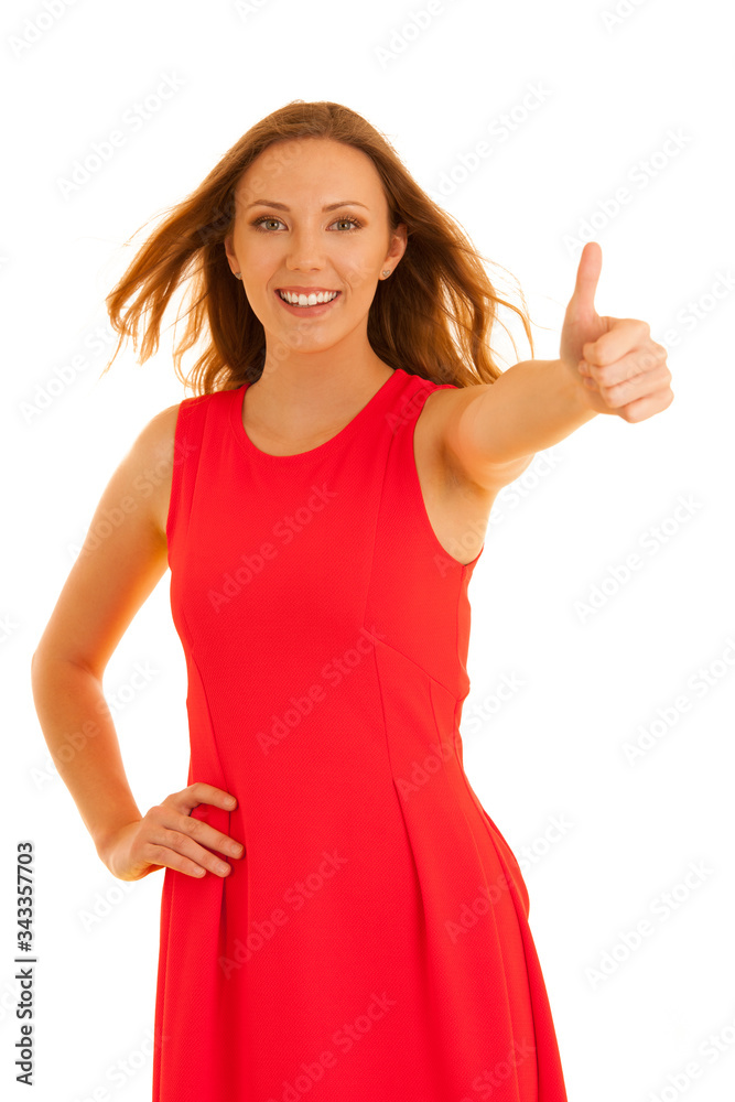 Beautiful young woman in red dress shows thumbs up as gesture for success Beautiful young woman in red dress shows thumbs up as gesture for success
