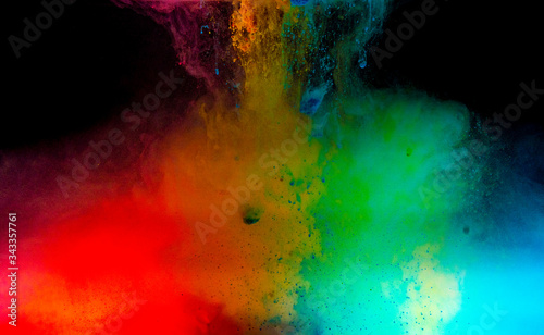Abstract art powder paint on black background. Movement abstract frozen dust explosion multicolored on black background.