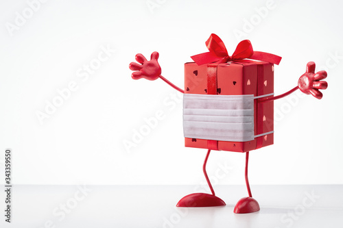 Gift in box. Red box on legs, with handles. Cartoon figure. Copy space. Gift in box. Red box in protective mask on legs, with handles. We defeat  virus. Cartoon figure. Copy space   © Kot63