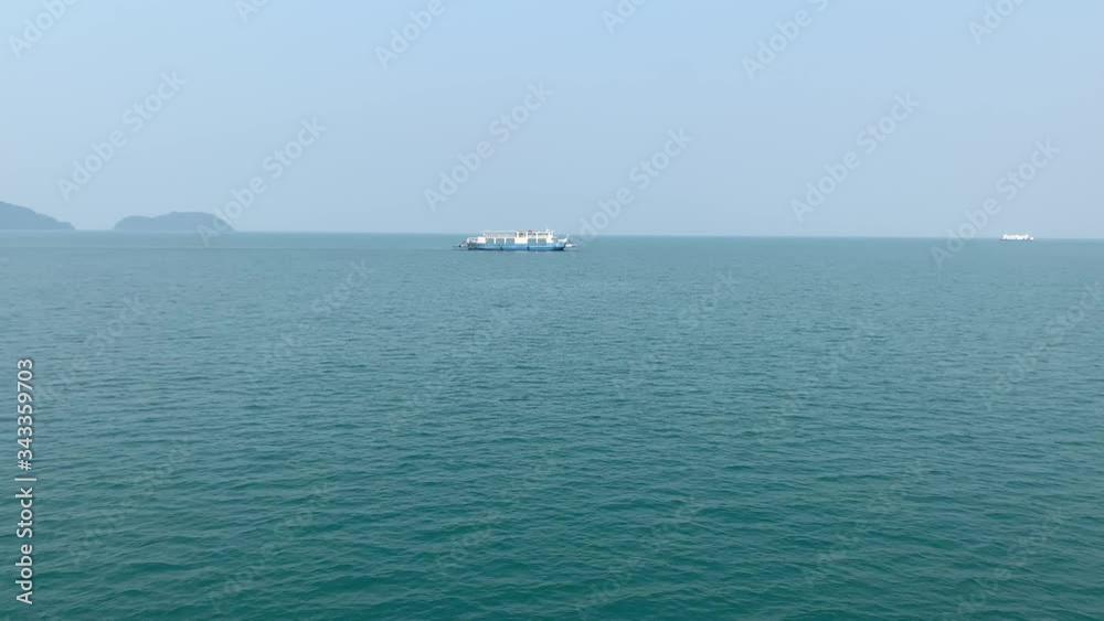 Calm Ocean Horizon With Clear Sky And Small Ferry Boat Calm Ocean Horizon With Clear Sky And Small Ferry Boat