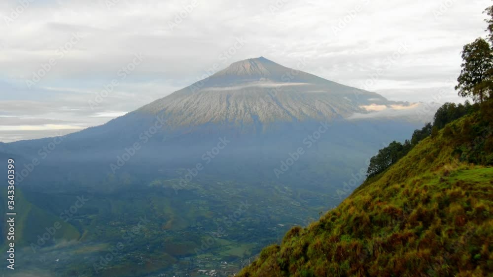 Aerial View Moving Shot, Man Descending Pergasingan Hill, Scenic View of Mount. Rinjani and Blue Sky in the background. Aerial View Moving Shot, Man Descending Pergasingan Hill, Scenic View of Mount. Rinjani and Blue Sky in the background.