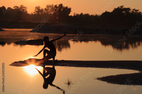 Touching the Sun at Sunrise in Kaolin Lakem Belitung, Indonesia photo