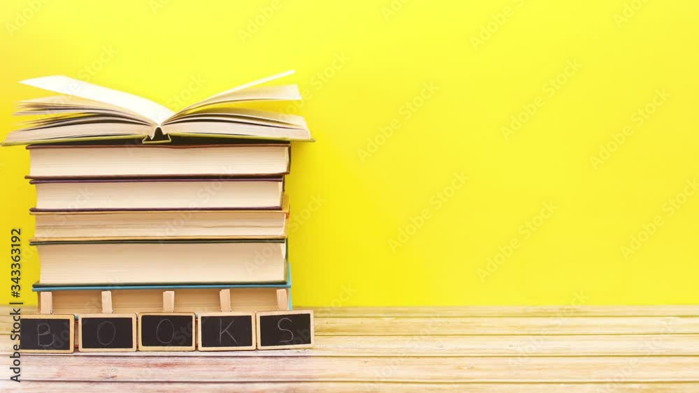 title books appear in front of pile of books with opened the last book - Stop motion 