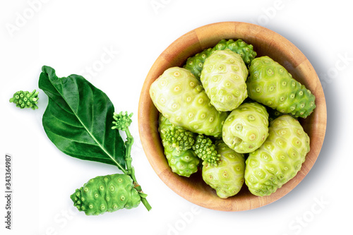 Fresh noni fruit ( morinda citrifolia indian mulberry, cheese fruit ) in wood bowl with green leaf isolated on white background. Top view. Flat lay.