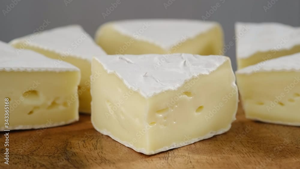Rotation pieces of soft cheese Camembert. light grey background. Delicious pieces of white mold cheeses with soft textures Camembert close up, macro Rotation pieces of soft cheese Camembert. light grey background. Delicious pieces of white mold cheeses with soft textures Camembert close up, macro