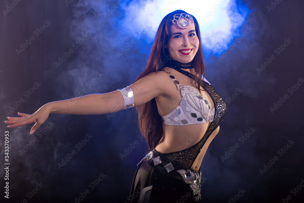 Spirituality dance. Beautiful sexy woman with luxury glossy eastern make-up dancing tribal fusion. Belly dance.