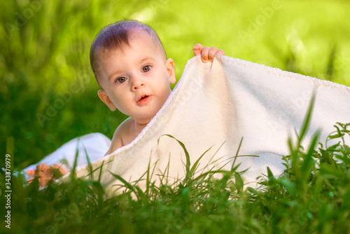 Little boy tried to hide from his parents using the blanket